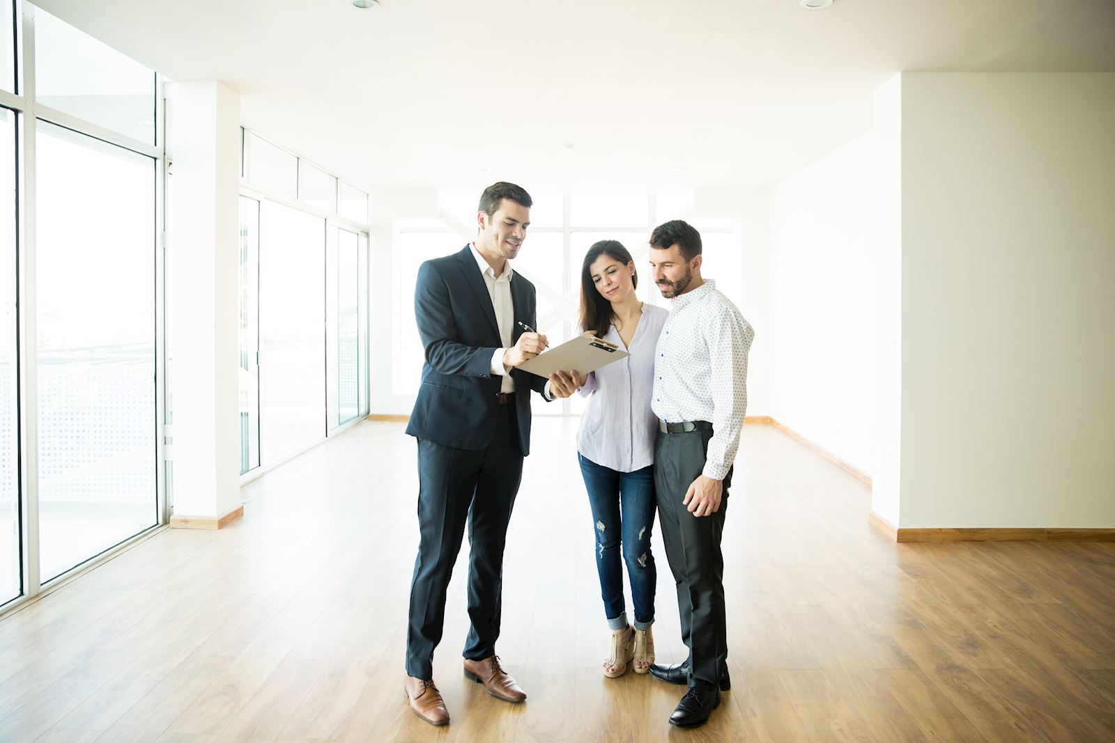 A real estate broker discusses plans with his chiropractor clients.